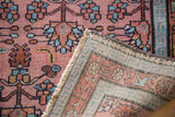 Malayer rug folded corner: allover dusty rose floral design, sky blue border reverse.