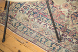 Antique Kerman rug border with Safavid-inspired dragon motif, cochineal red floral patterns, and visible wear.