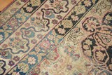 Antique Lavar Kerman's unique reciprocating border with floral motifs in red and navy.