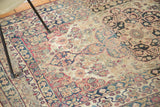 Antique Lavar Kerman rug's cochineal red, navy floral motifs, unique reciprocating border.