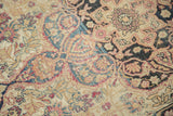 Worn antique Kerman rug pile with traditional floral motifs in beige, sky blue, and cochineal red.