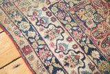 Antique Kerman rug border with reciprocating dragon motif in navy and cochineal red.