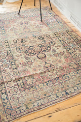 Antique Lavar Kerman rug's oversized medallion, Safavid-inspired border, cochineal red, navy, and ivory.