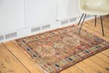 Antique Caucasian rug with distressed tribal geometric design, brick red, ivory, tattered ends.