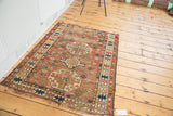 Antique Caucasian rug's distressed aesthetic with geometric designs and tattered ends.
