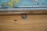 Close-up of antique map's wooden dowel and 'British Isles' metal tag.