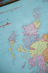 Antique British Isles map section with vibrant pink, yellow, and blue landmasses of Scotland.