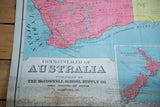 Antique Australia map: publisher text, vibrant pink region, bottom edge discoloration.
