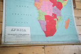 Early 20th century Africa map bottom view: orange Madagascar, dowel, and edge patina.