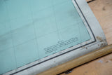 Antique Africa map's bottom edge with teal grid, coordinate note, and discolored border.