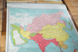 Late 19th century pull-down map of Asia with vibrant pink, yellow, and green countries.