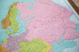 Vibrant pink, green, and blue landmasses on a detailed section of the antique Europe map.