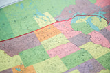 Vintage school map close-up with vibrant upper Midwest states and detailed geographic typography.