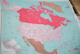 Vintage North America map detail showing vibrant red Canada, pink USA, and clear typography.
