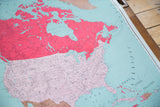Antique North America map detail, pink U.S., teal Atlantic, and bottom discoloration.