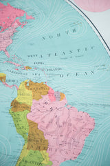 Antique Western Hemisphere map detail, showing vibrant typography and pastel landmasses of South America.