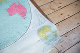 Vintage Eastern Hemisphere map detail, featuring yellow lands, blue oceans, and visible bottom wear.