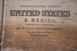 Close-up of W. & A.K. Johnston antique map title with Edinburgh publisher text, showing aged paper and wear.