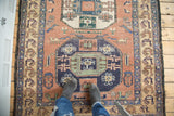 Vintage Meshkin rug with geometric octagonal medallion, dusty blush field, and pictorial border.