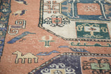 Vintage Meshkin rug's dusty blush field features geometric camels, birds, and rectilinear motifs.