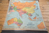 Vintage Nystrom pull-down map of Asia and Australia, bright colors, lower dowel.