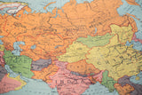 Central Asia section of vintage map with orange USSR, green Iran, and yellow China.