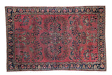 Distressed vintage Lilihan rug, burgundy field, navy border with palmettes and floral vines.
