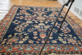 Antique Mohajeran Sarouk rug corner, blush rose main border with meandering palmette design.
