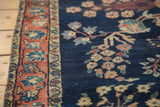 Antique Farahan Mohajeran Sarouk rug's blush rose palmette border and dark blue floral field.