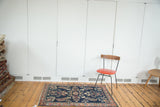 Dark blue field with aqua blue and teal palmette motifs, blush rose border.