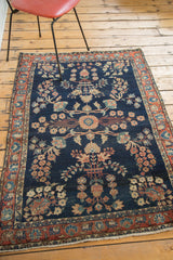 Meandering palmette pattern on dark blue Mohajeran Sarouk rug with blush rose border.