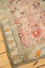 Distressed Laleh Abbasi minor border and tribal geometric patterns in faded red, charcoal, tan.