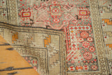 Antique Caucasian rug's structured hand-knotted foundation and re-selvaged edge with distressed geometric pile.