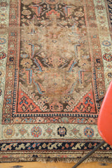 Intricate lower borders, short worn fringe, and aged patina of an antique Demirci rug.