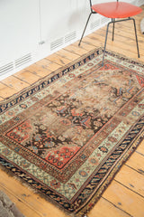 Antique Turkish Demirci rug corner, showcasing worn pile, rust, sage, and navy borders.