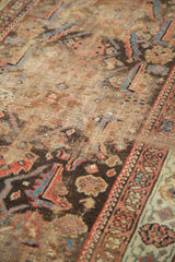 Antique Demirci rug's textured pile, showing earth tones and subtle blue, red motifs.