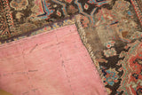 Pink silk linen backing remaining on antique Demirci rug, revealing worn pile.