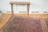 Antique Malayer rug's dark blue herati pattern with prominent striated greige abrash.