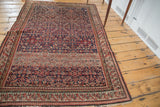 Antique Malayer rug with dark blue herati pattern and prominent striated abrash.