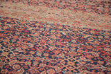 Detailed Herati motif weaving in red, blush, and dark blue on antique Malayer rug.