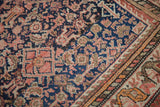 Antique Malayer rug detail, tight herati weaving on a dark blue field with blush and greige accents.