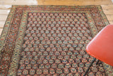 Antique Kurdish rug's dense field, featuring variegated boteh motifs in rainbow colors.