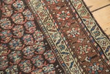 Vibrant hand-knotted antique Kurdish rug with intricate floral and boteh motifs.
