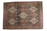 Antique Lavar Kerman carpet featuring a multi-paneled allover design in deep blue, rust-red, and ivory tones.