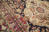 Detailed view of hand-knotted floral motifs and rare part-silk areas on an antique Kerman carpet.