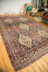 A collector's antique Lavar Kerman carpet showing the full scope of its complex multi-paneled pattern.