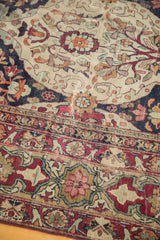 Storied, multi-paneled border and distressed ivory field of an antique collector Kerman carpet.