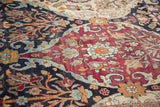 Detail of the time-softened pile and hand-knotted floral motifs on an antique Lavar Kerman carpet.