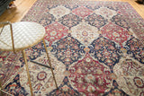 Styled view of a late 19th-century Lavar Kerman carpet with paneled floral motifs.