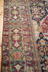 Intricate multi-banded floral border against the dark navy field of a collector's Lavar Kerman carpet.
